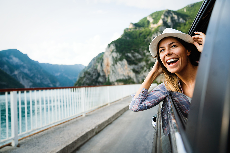 bigstock Woman In Car Road Trip Waving 433095494