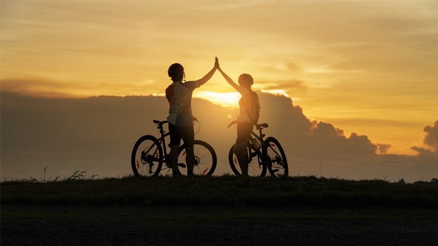young-couple-having-fun-outdoors-biking young-couple-having-fun-outdoors-biking